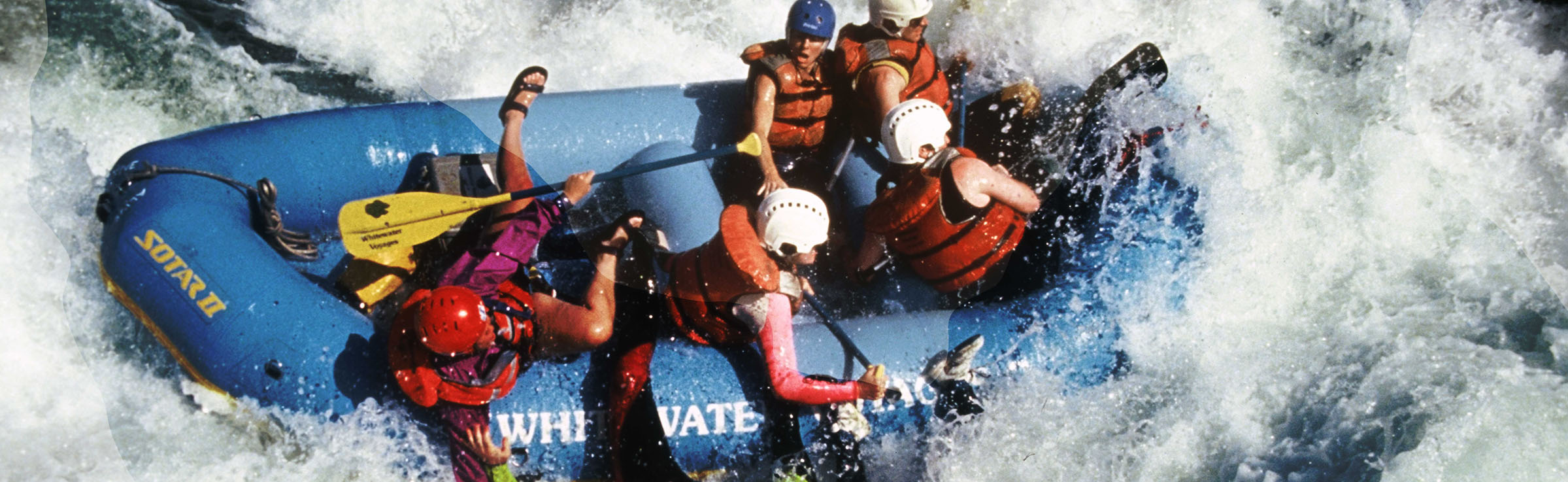 people whitewater rafting in big rapids