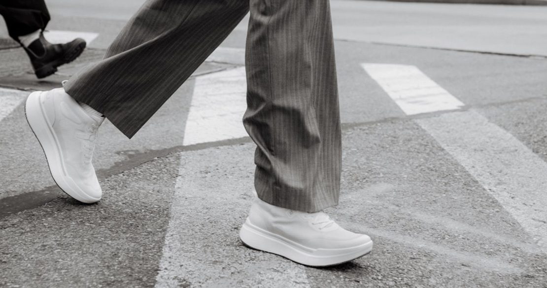 Close up walking in street wearing AHNU shoes