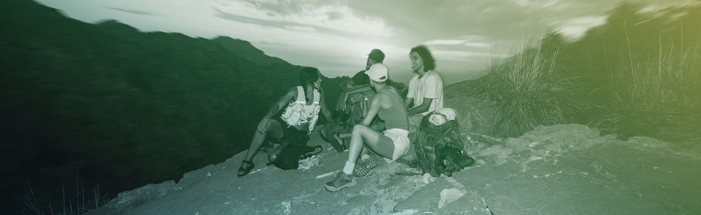 A group of people sitting on a mountain