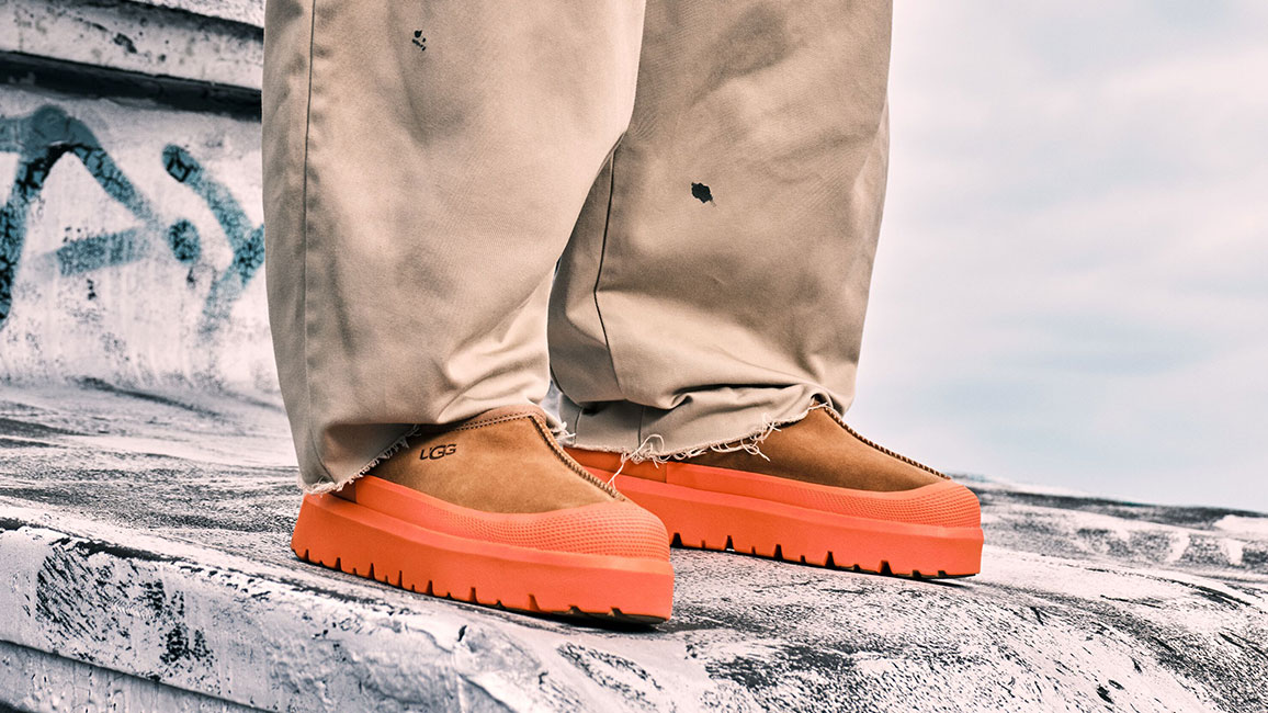 A person wearing orange shoes